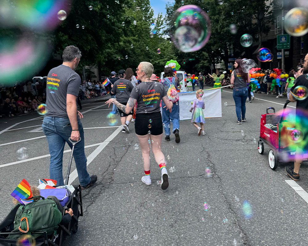two members of TVES walking in parade with bubbles